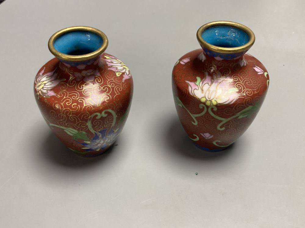 A group of Chinese wood stands and cloisonne enamel vases